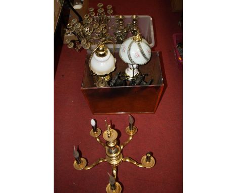 A large collection of various lighting and ornaments to include a pair of brass table candelabra and a pair of spelter models