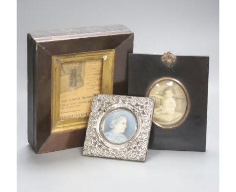 A small silver framed portrait miniature and two picture frames