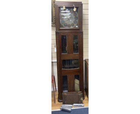 A large and unusual 20th century oak cased longcase clock, in the arts and crafts style, after Mackintosh, the 13" engraved d