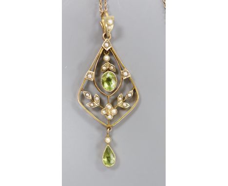 An early 20th century 9ct, peridot and seed pearl set drop pendant, 54mm, on a fine link yellow metal chain, 42cm,gross 5.1 g