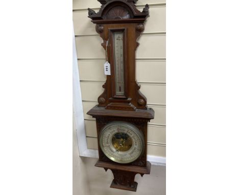 A Victorian carved mahogany wall hanging barometer, the silvered dial marked H. Hughes &amp; Sons, 59 Fenchurch Street, Londo