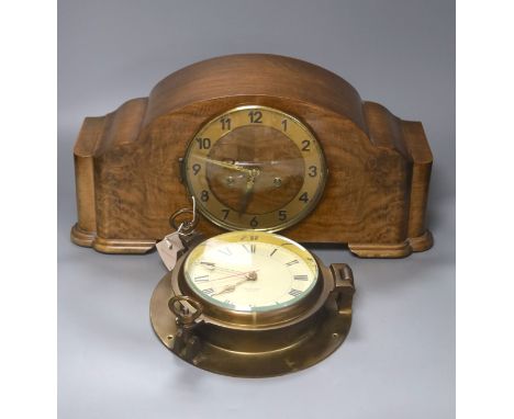 A 1920's walnut cased mantle clock, 42cm wide, 14cm deep, 22cm high and a brass bulkhead wall clock, 22cm diameter.