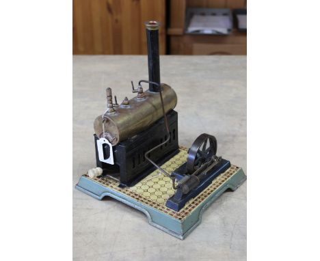 A vintage Gebrueder Bing static steam engine on faux tile stand 