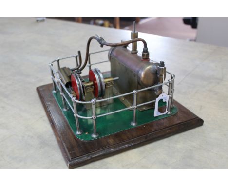 A vintage hand built model steam engine with chrome railings