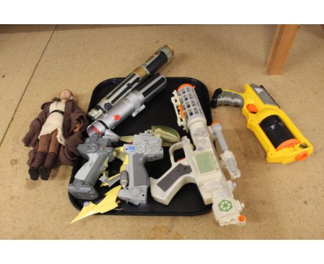A selection of Star Wars items including two light sabers, blaster and nerf gun plus a figure of Qui-Gon-Jinn