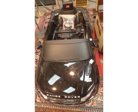 Child's black battery powered Range Rover with remote control, two years old   CONDITION REPORT:  This item is working at lot