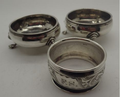 Three silver items; two open salts and a napkin ring