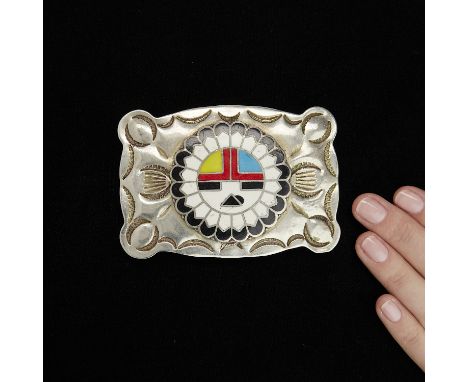 One rectangular form belt buckle with stamped designs and inlaid kachina design rendered in black, white, red, yellow and blu