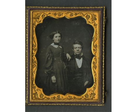 Quarter plate Daguerreotype photograph depicting a portrait of a couple. The woman is standing with her hand resting on the s