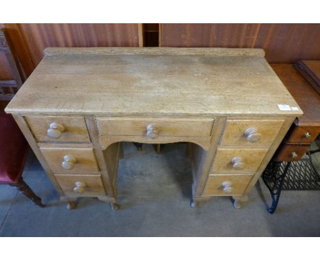 A light oak kneehole desk