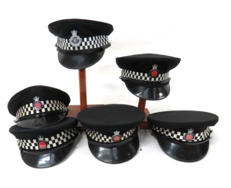 Six Post 1953 Police Officer Capsconsisting 5 x dark blue examples with black and white checkered bands.  Plated and enamel, 