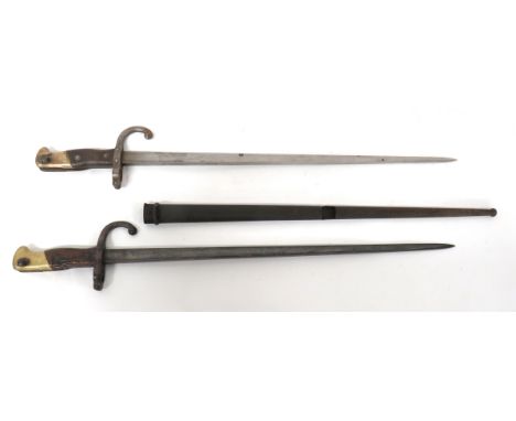 Two French M1874 Gras Bayonetconsisting 20 1/2 inch, T section blade.  Back edge with maker dated 1876.  Steel muzzle ring an
