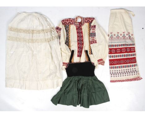 A selection of vintage traditional Dutch outfits. Comprising a child's black velvet and green skirted 'milkmaid' dress, a cot