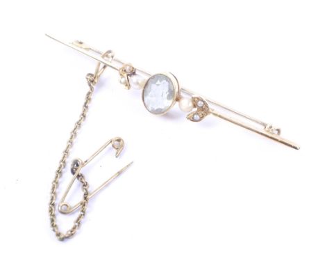 An early 20th century gold, pale aquamarine and seed-pearl three stone bar brooch. Stamped '15ct', base-metal pin, 3.2g gross