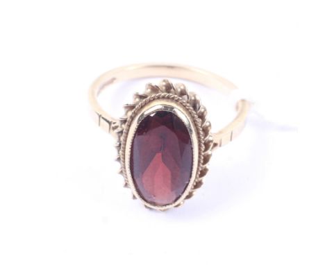 A vintage 9ct gold and oval garnet single stone ring. Birmingham convention hallmarks, size K, 2.5g gross