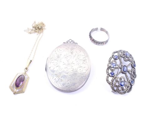 A small group of jewellery including an open oval brooch set with navy-blue pastes and marcasites. A rolled-gold and purple-p