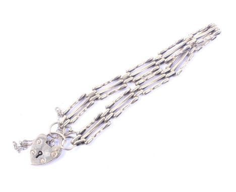 A vintage 9ct gold three-bar 'gate' bracelet. On a heart-shaped padlock clasp with hallmarks for Birmingham 1994, 8.9g gross