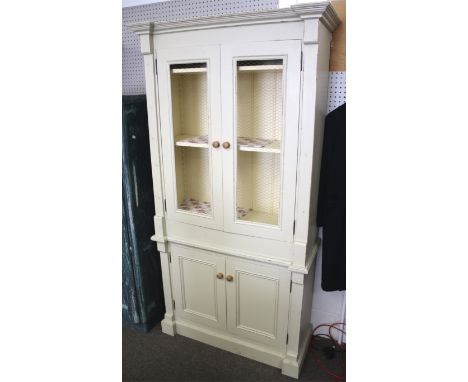 A contemporary French distressed style painted dresser cupboard. A two piece, top section with two doors open 'chicken wire' 