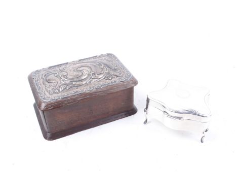 Two early 20th century silver mounted trinket boxes. One shaped with an engine turned hinged cover on four pad feet, Birmingh