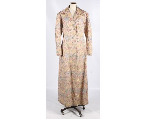 A vintage overcoat in the Chinese style. Full length sleeves with two button fastenings. The pink silk blend fabric woven wit