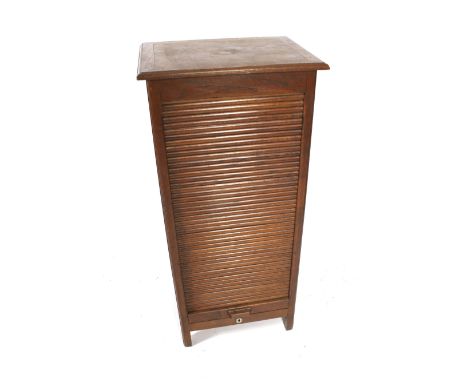 A tall oak tambour cabinet. With various compartments and shelf rails to the inside. H118cm x W55cm x D43cm