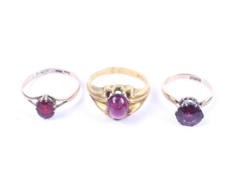 Three early 20th century gold and single stone rings. Comprising; a 9ct gold and oval cabochon paste single stone ring, hallm