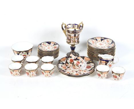 A large 20th century Crown Derby tea service. In the Imari pattern 6041, comprising ten cups, eleven saucers, twelve small pl