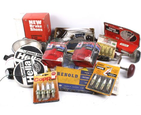 A box of assorted vintage car parts, accessories and tools.  Including lights, head light covers and spark plugs, etc. 