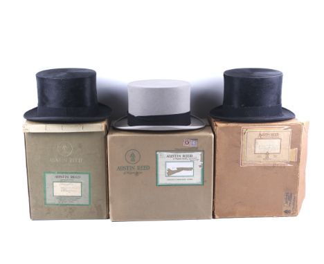 Three Austin Reed vintage top hats. Comprising a black silk hat with cream lining, inner circumference 57.5cm, a grey felt to