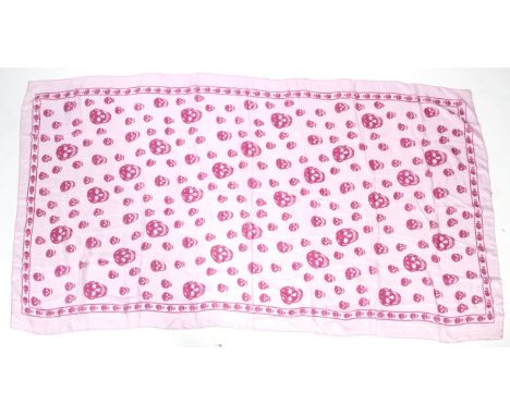 A vintage silk scarf in the style of Alexander McQueen. Printed with pink skulls on a pink ground, 180cm x 105cm