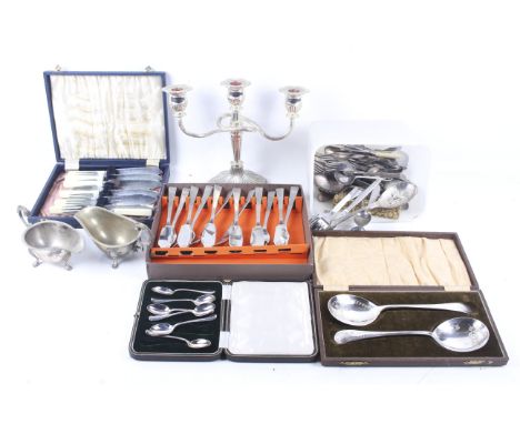 An assortment of silver plate. Including flatware, a candelabrum, boxed spoons and more