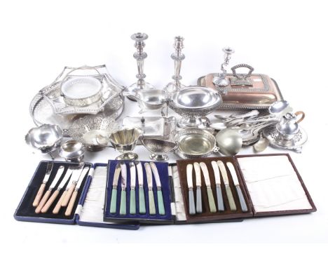 A collection of silver-plate. Including a pair of weighted candlesticks, a butter dish, flatware, candlesticks and more