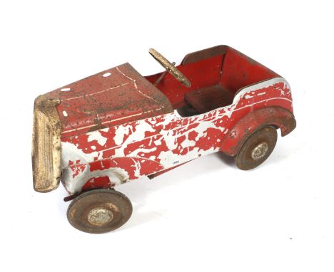 A vintage Tri-ang child's ride-on toy car. With remains of red enamelling, white stearing wheel and tall front grill, circa L