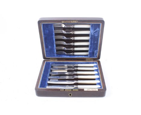 A set of six silver and mother of pearl handled tea knives. Mark of Walker & Hall, Sheffield 1934; in an oak case