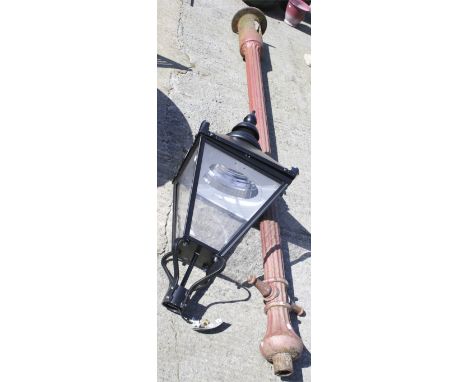A vintage cast iron lamp post with a modern light fitting. Post measures 324cm long and the light H120cm