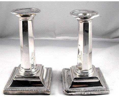 A pair of Edwardian silver candlesticks with octagonal column on a stepped square base, Birmingham 1908 13cm high 