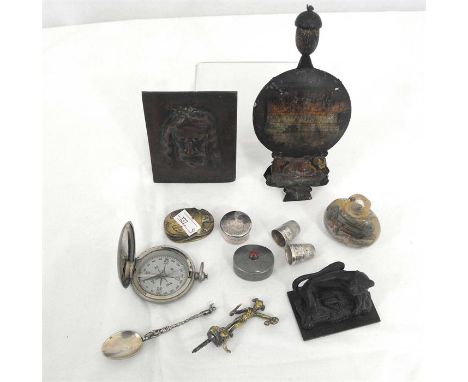 A brass plaque, "Le Saint Suair de Turin" signed "Coutin", 7cm by 10cm; a brass finial depicting Perseaus; a pocket compass a
