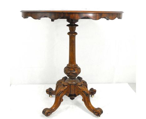 A Victorian walnut tilt-top occasional table on carved and turned column with quatrofoil base, 67cm wide. 