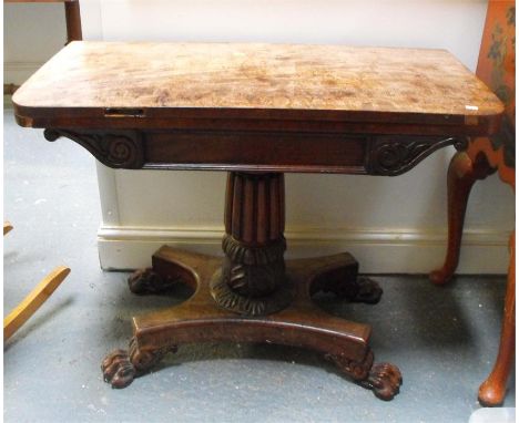 A William IV mahogany pedestal card table, on quatrofoil base with carved lion paw feet, 90cm wide. 