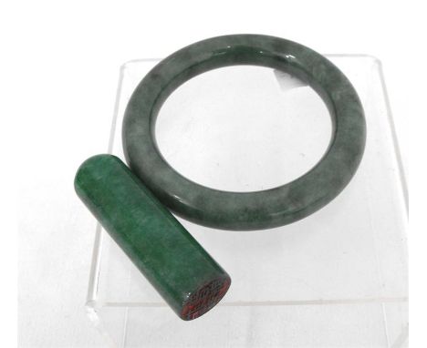 A green jade desk seal, 6cm high; and a green jade oblique Jadeite bangle, 8cm diameter (2).