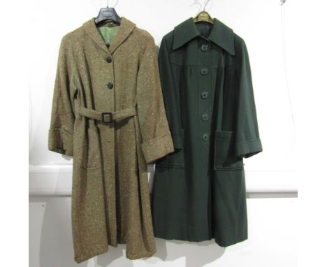 A  dark green wool coat with a large collar, turn back cuffs, seamed yolk, two large patch pockets to the front and a green c