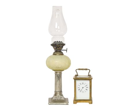 A Victorian oil lamp, with EPNS columnar base, semi-opalescent font and brass burner, 39cm h and a French brass carriage cloc