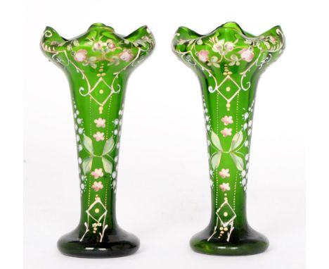 A pair of green glass spill vases, c 1900, enamelled in polychrome with roses, lily of the valley, and scrolling leafy foliag