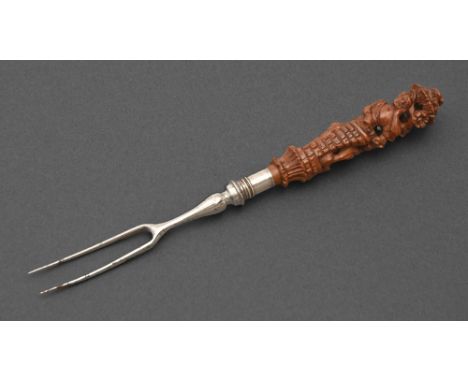 A Northern European steel two-prong fork with finely carved boxwood handle, late 17th-early 18th c, the handle in the form of