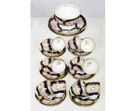 A Coalport tea service, c1850, painted with flowers reserved on a blue ground, the service including a pair of plates, 24.5cm