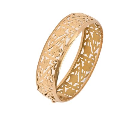A gold bangle, pierced with panels of stylised tulips and other flowers, marked 18k, 31g  