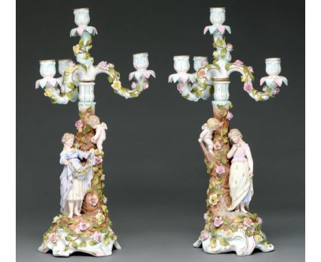 A pair of Plaue floral encrusted candelabra, c1900, of three lights on scrolling branches, the rustic candlestick base set wi