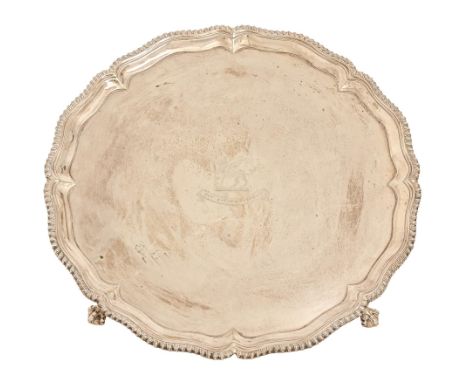 A George III silver salver, with gadrooned rim, on claw and ball feet, engraved with crest and motto, 38.5cm diam, by John Cr