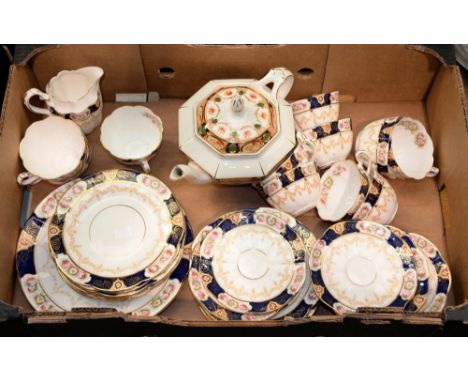 A William Lowe bone china tea service, pre-1912, the cobalt border reserved with panels of roses, printed mark and a Stafford