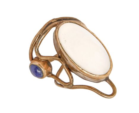 An Arts &amp; Crafts moonstone and lapis lazuli wirework ring,&nbsp; in gold, unmarked, 8.2g, size Q  Good condition
